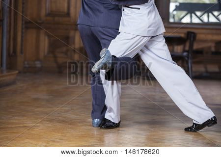 Tango Dancers Performing Gancho Step In Restaurant