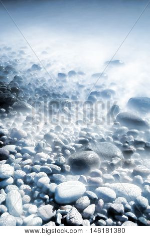 Background of water and rolling stones at Moelen