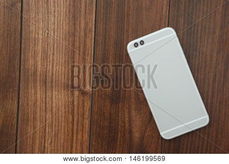 Modern Dual Rear Camera Smart Mobile Phone On Wooden Surface