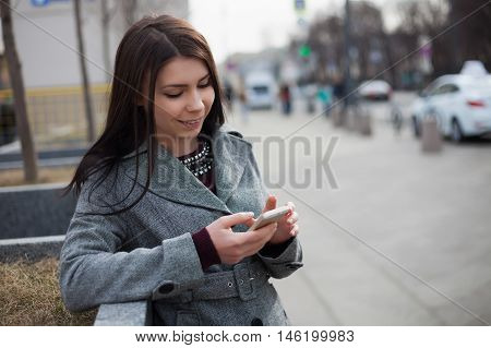 Young Brunette Girl Using Modern Smart Phone