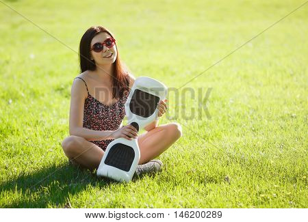 Girl With Electric Mini Hover Board Scooter In Park