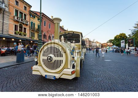 Verona Italy - May 07 2016: Some people have fun to ride on the tourist train on a Bra square