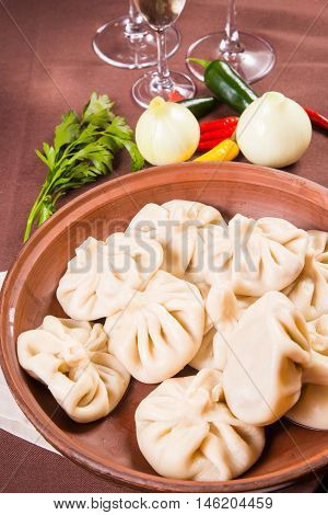 hot fresh georgian food,hinkali with parsley in restaurant