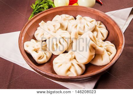 hot fresh georgian food,hinkali with parsley in restaurant