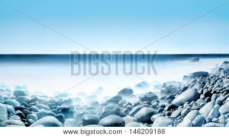 Background of water and rolling stones at Moelen