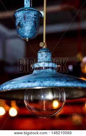 Old grunge blue lamp with wide lampshade and round glass bulb
