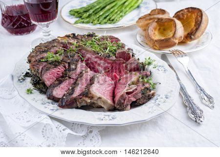 Sliced Porterhouse Steak with Yorkshires and Green Asparagus on Plate