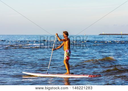 Kijkduin beach the Netherlands - September 01 2016: Male stand up board paddler