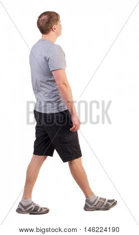 Back view of walking handsome man in shorts and sneakers.   Sports-dressed young man moves. going young guy. Rear view people collection.  backside view of person.  Isolated over white background