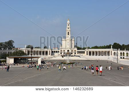 FATIMA, PORTUGAL - AUG 24: Sanctuary of Fatima in Portugal, as seen on Aug 24, 2016. It consists of a tall centralized bell-tower and nave, 213 ft in height, decorated by a 15,000 lb crown of bronze.