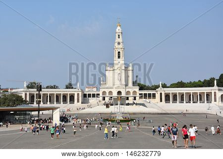 FATIMA, PORTUGAL - AUG 24: Sanctuary of Fatima in Portugal, as seen on Aug 24, 2016. It consists of a tall centralized bell-tower and nave, 213 ft in height, decorated by a 15,000 lb crown of bronze.