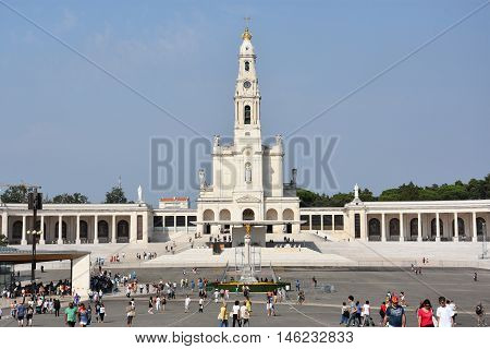 FATIMA, PORTUGAL - AUG 24: Sanctuary of Fatima in Portugal, as seen on Aug 24, 2016. It consists of a tall centralized bell-tower and nave, 213 ft in height, decorated by a 15,000 lb crown of bronze.