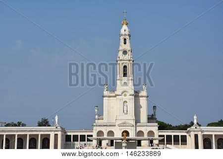 FATIMA, PORTUGAL - AUG 24: Sanctuary of Fatima in Portugal, as seen on Aug 24, 2016. It consists of a tall centralized bell-tower and nave, 213 ft in height, decorated by a 15,000 lb crown of bronze.