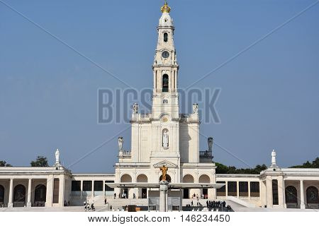 FATIMA, PORTUGAL - AUG 24: Sanctuary of Fatima in Portugal, as seen on Aug 24, 2016. It consists of a tall centralized bell-tower and nave, 213 ft in height, decorated by a 15,000 lb crown of bronze.