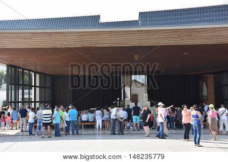 FATIMA, PORTUGAL - AUG 24: Sanctuary of Fatima in Portugal, as seen on Aug 24, 2016. It consists of a tall centralized bell-tower and nave, 213 ft in height, decorated by a 15,000 lb crown of bronze.