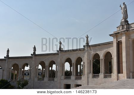 FATIMA, PORTUGAL - AUG 24: Sanctuary of Fatima in Portugal, as seen on Aug 24, 2016. It consists of a tall centralized bell-tower and nave, 213 ft in height, decorated by a 15,000 lb crown of bronze.