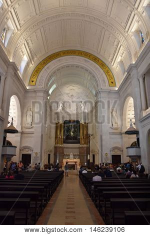 FATIMA, PORTUGAL - AUG 24: Sanctuary of Fatima in Portugal, as seen on Aug 24, 2016. It consists of a tall centralized bell-tower and nave, 213 ft in height, decorated by a 15,000 lb crown of bronze.