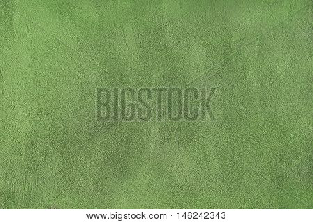 Background of a lime green stucco coated and painted exterior rough cast of cement and concrete wall texture decorative coating