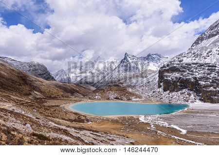 Milk lake in peak of snow mountains at Yading Nature Reserve, China.