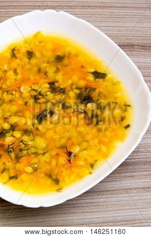 A plate of pea soup is on the table
