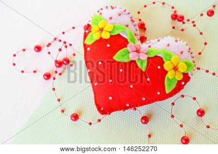 Hand stitched felt heart. Symbol of Valentines Day. Handmade felt toy