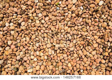 Sea stones Orange brown rock pebbles background