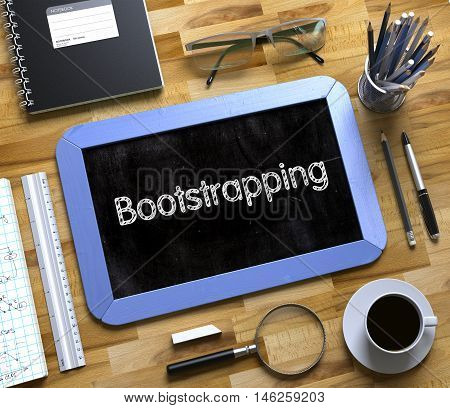 Bootstrapping - Text on Small Chalkboard.Top View of Office Desk with Stationery and Blue Small Chalkboard with Business Concept - Bootstrapping. 3d Rendering.