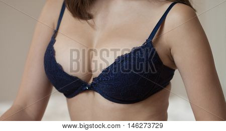 brunette lady with big natural boobs in blue lingerie