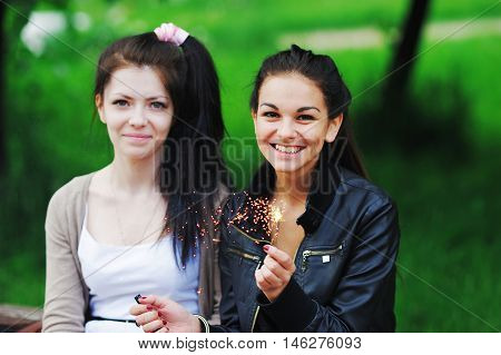 Portrait Of A Happy Young Women With Long Dark Hair. Two Beautiful Girlfriend Was Found In The Summe