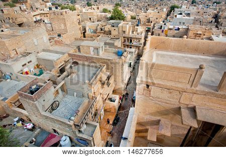 JAISALMER, INDIA - MAR 1, 2015: High point view on the streets of poor area in historical indian town on March 1, 2015. Jaisalmer lies in the heart of the Thar Desert and has a population of about 78000.