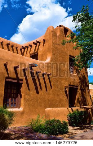 Southwest adobe style building beside a garden taken in Santa Fe, NM
