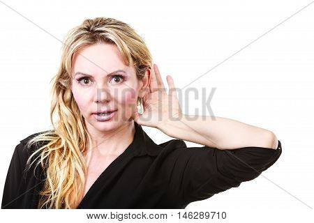 Gossip and chatter. Blonde mid aged woman listening hearing rumors information. Elegant mature female in black isolated on white.