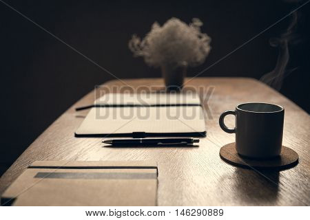 Coffee table with cup of coffee smoking in coffee shop. Relaxing in coffee shop.