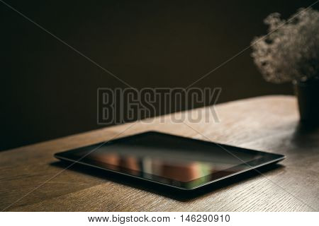Blank table and little plant on wooden coffee table.