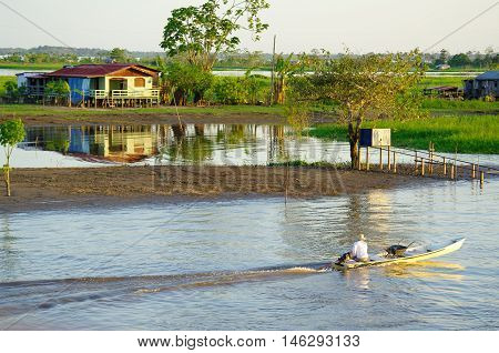 Fisherman On A Rowboat On Amazon River.