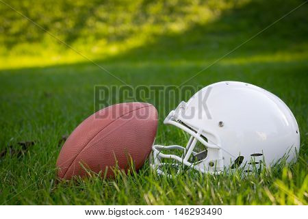 American Football and Helmet on the field.