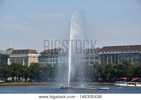 HAMBURG, GERMANY - AUG 26: Fountain at Alster Lake in Hamburg, Germany, as seen on Aug 26, 2016. In the city center, the Alster river forms two lakes, both prominent features in Hamburg's cityscape.
