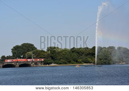 HAMBURG, GERMANY - AUG 26: Fountain at Alster Lake in Hamburg, Germany, as seen on Aug 26, 2016. In the city center, the Alster river forms two lakes, both prominent features in Hamburg's cityscape.