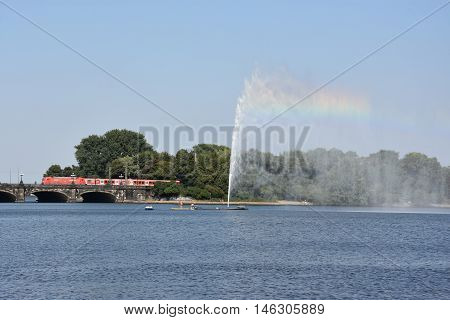 HAMBURG, GERMANY - AUG 26: Fountain at Alster Lake in Hamburg, Germany, as seen on Aug 26, 2016. In the city center, the Alster river forms two lakes, both prominent features in Hamburg's cityscape.
