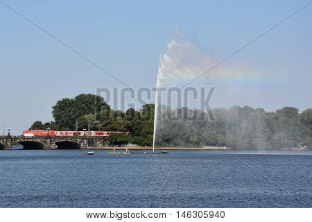 HAMBURG, GERMANY - AUG 26: Fountain at Alster Lake in Hamburg, Germany, as seen on Aug 26, 2016. In the city center, the Alster river forms two lakes, both prominent features in Hamburg's cityscape.