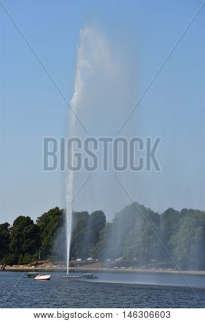 HAMBURG, GERMANY - AUG 26: Fountain at Alster Lake in Hamburg, Germany, as seen on Aug 26, 2016. In the city center, the Alster river forms two lakes, both prominent features in Hamburg's cityscape.