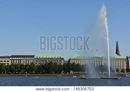 HAMBURG, GERMANY - AUG 26: Fountain at Alster Lake in Hamburg, Germany, as seen on Aug 26, 2016. In the city center, the Alster river forms two lakes, both prominent features in Hamburg's cityscape.
