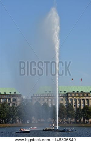 HAMBURG, GERMANY - AUG 26: Fountain at Alster Lake in Hamburg, Germany, as seen on Aug 26, 2016. In the city center, the Alster river forms two lakes, both prominent features in Hamburg's cityscape.