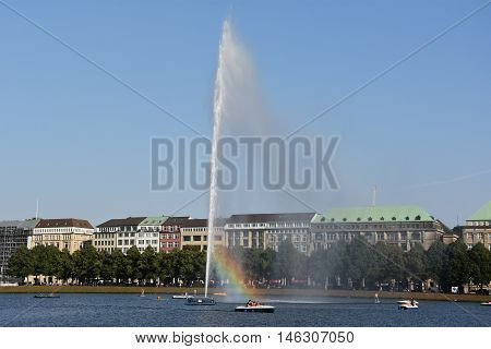 HAMBURG, GERMANY - AUG 26: Fountain at Alster Lake in Hamburg, Germany, as seen on Aug 26, 2016. In the city center, the Alster river forms two lakes, both prominent features in Hamburg's cityscape.