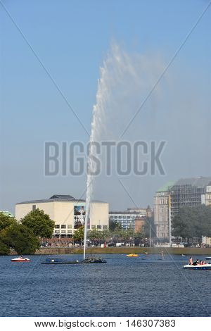 HAMBURG, GERMANY - AUG 26: Fountain at Alster Lake in Hamburg, Germany, as seen on Aug 26, 2016. In the city center, the Alster river forms two lakes, both prominent features in Hamburg's cityscape.