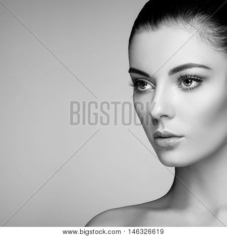 Beautiful woman face. Perfect makeup. Beauty fashion. Eyelashes. Cosmetic Eyeshadow. Highlighting. Black and White