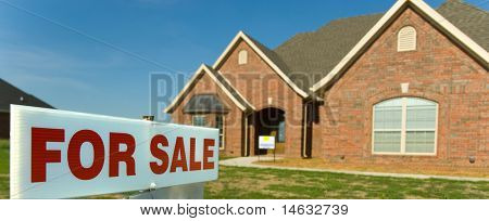 For sale sign in front of new home