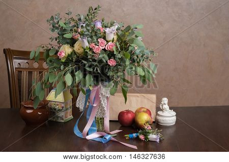 Still-life with a bouquet of flowers and apples