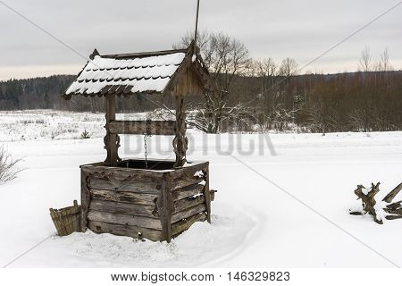 abandoned well on a winter forest background