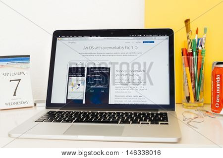 PARIS FRANCE - SEP 8 2016: Apple Computers website on MacBook Pro Retina in a geek creative room environment showcasing Siri Specs